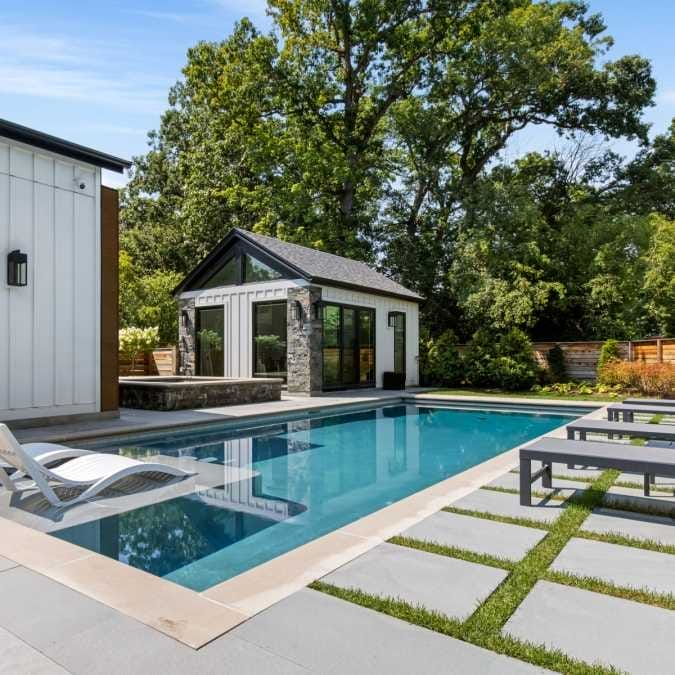 Outdoor Living Space Overlooking In-ground Pool and Custom Art Studio