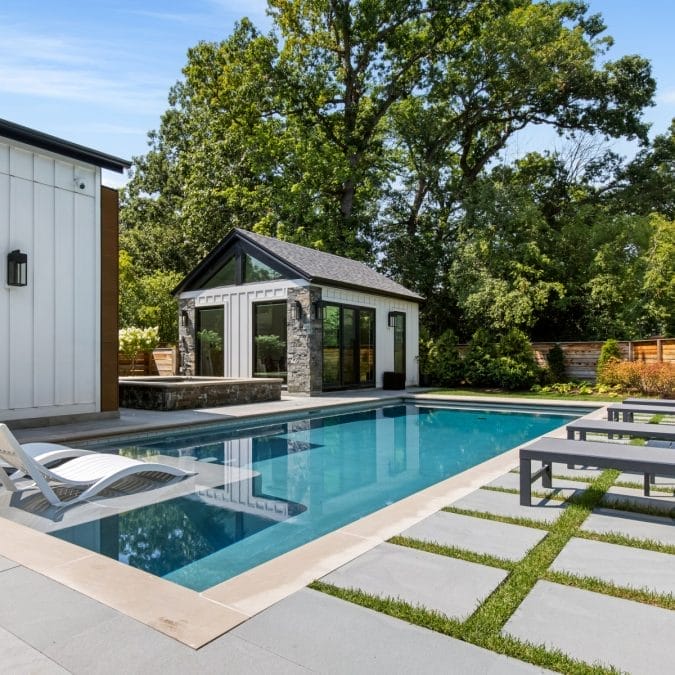 Outdoor Living Space Overlooking In-ground Pool and Custom Art Studio