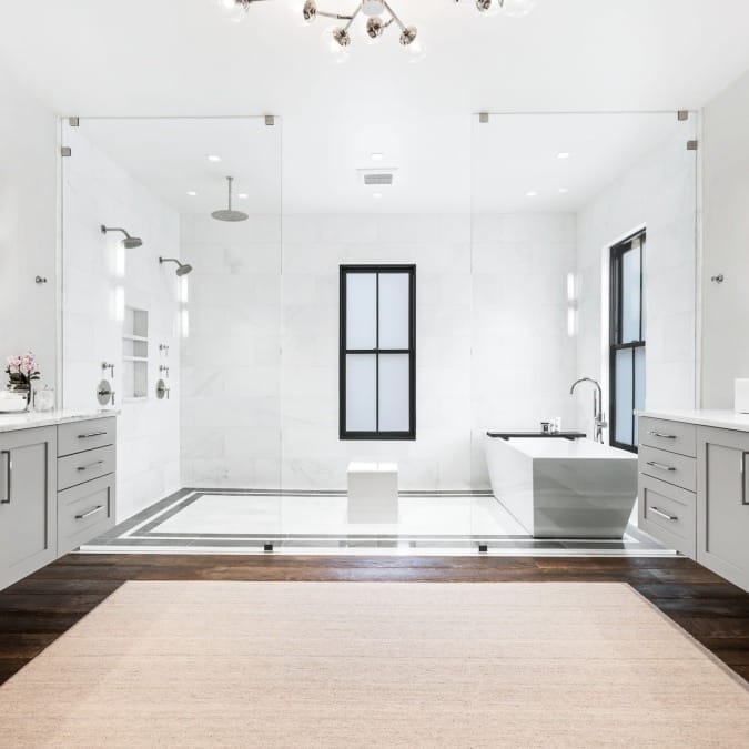Dual Floating Vanities Adjacent to Wet Room with Free Standing Tub